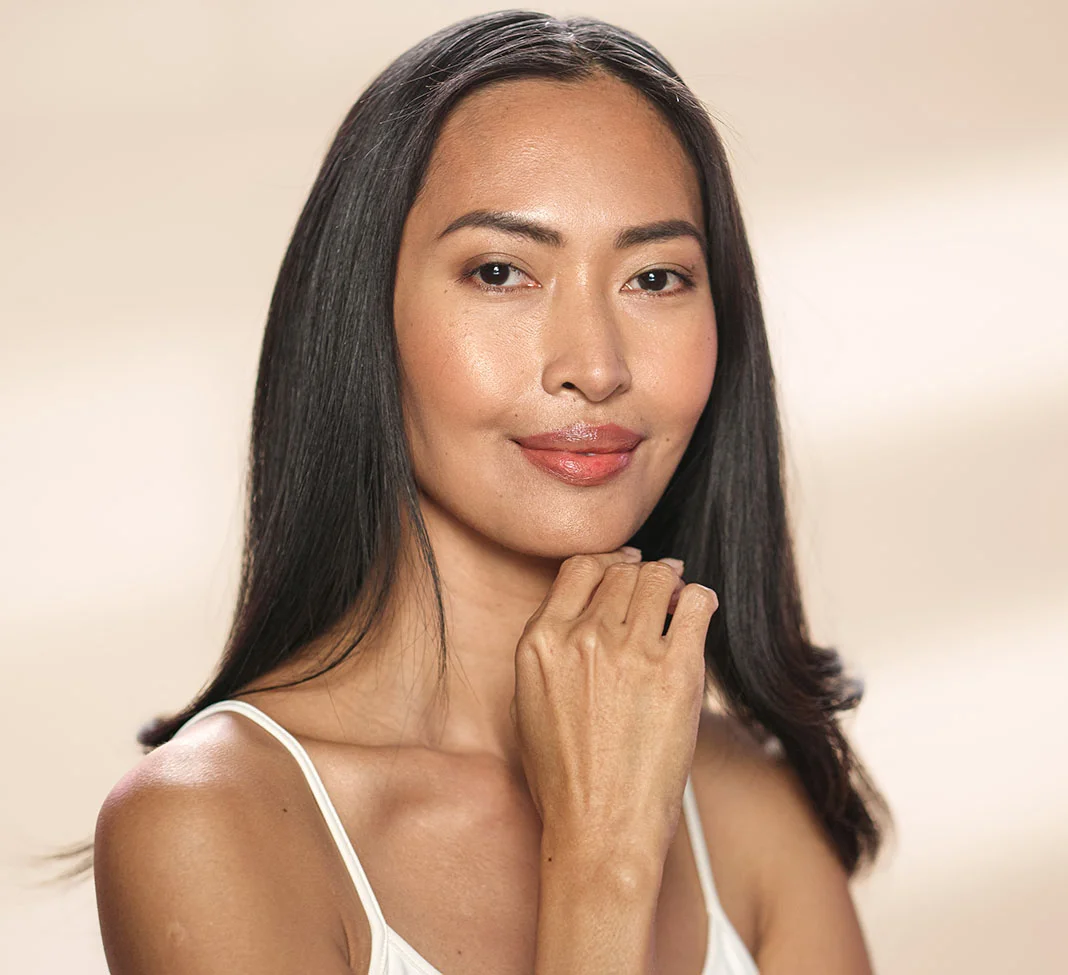 Asian middle aged woman with her hand on her chin | RF Microneedling | NYC